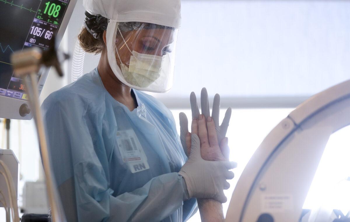 A nurse performs range of motion exercises on a patient in the Intensive Care Unit (ICU) at Sharp Grossmont Hospital in La Mesa, Calif., on May 5, 2020. (Mario Tama/Getty Images)