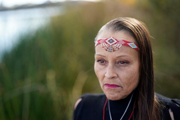 Moonlight Pulido poses for a portrait by the shore at Harbor Lake in Los Angeles, on Dec. 7, 2022. (Marcio Jose Sanchez/AP Photo)