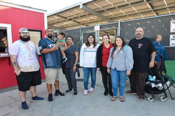 Francisco “Paco” Gonzalez holding his son with his family at a game. (Courtesy of Mai Lam)