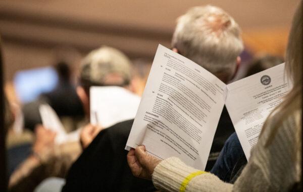 Residents look through city council agenda items at the Huntington Beach Civic Center in Huntington Beach, Calif., on Jan. 17, 2023. (John Fredricks/The Epoch Times)