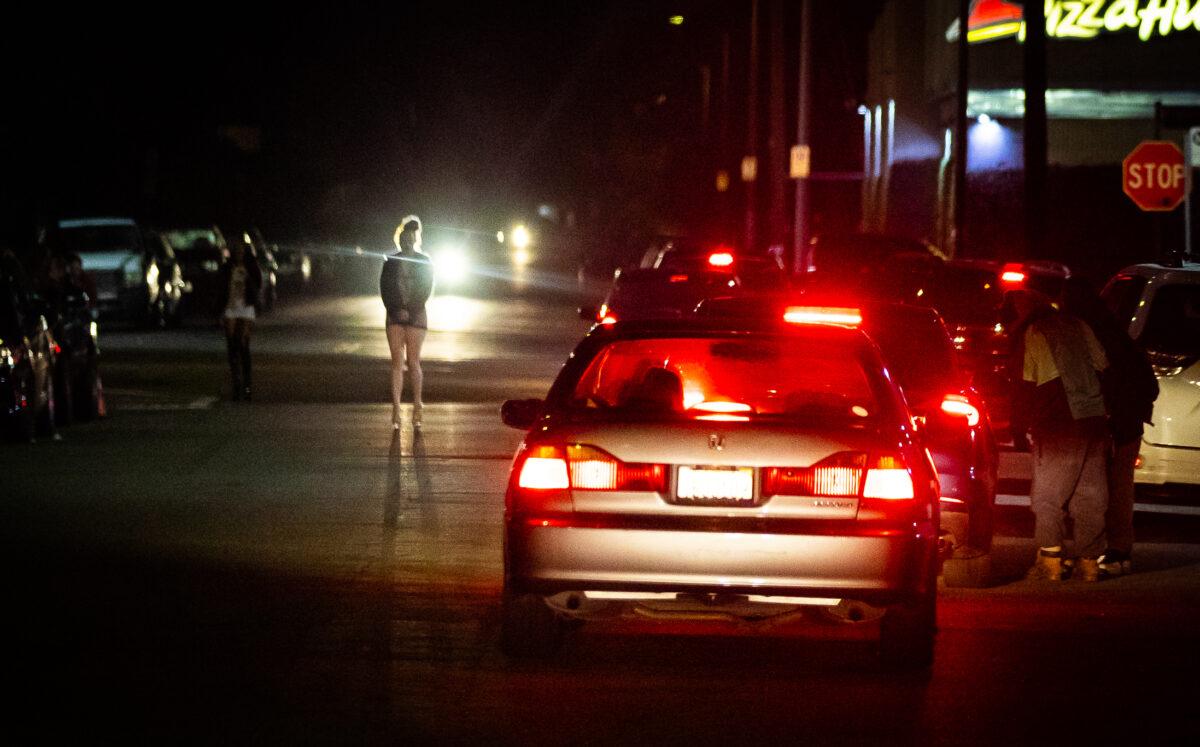 Women stand in "The Blade" area of Los Angeles on Feb. 8, 2023. (John Fredricks/The Epoch Times)