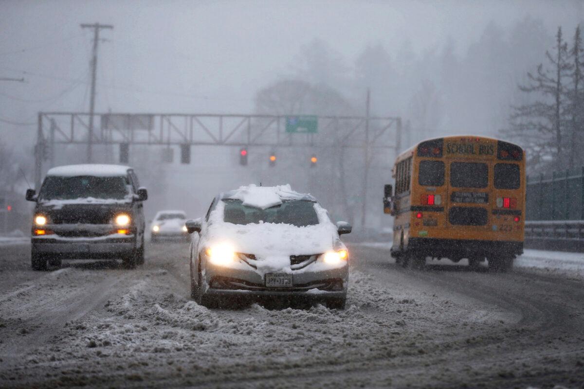Vehicles drive on the Rosa Parks overpass at Interstate-5 during a snowstorm in Portland, Ore., on Feb. 22, 2023. (Dave Killen/The Oregonian via AP)