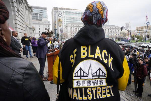 Eric McDonnell, Chair with the African American Reparations Advisory Committee (middle left) speaks at a reparations rally outside of City Hall in San Francisco, on March 14, 2023. (Jeff Chiu/AP Photo)