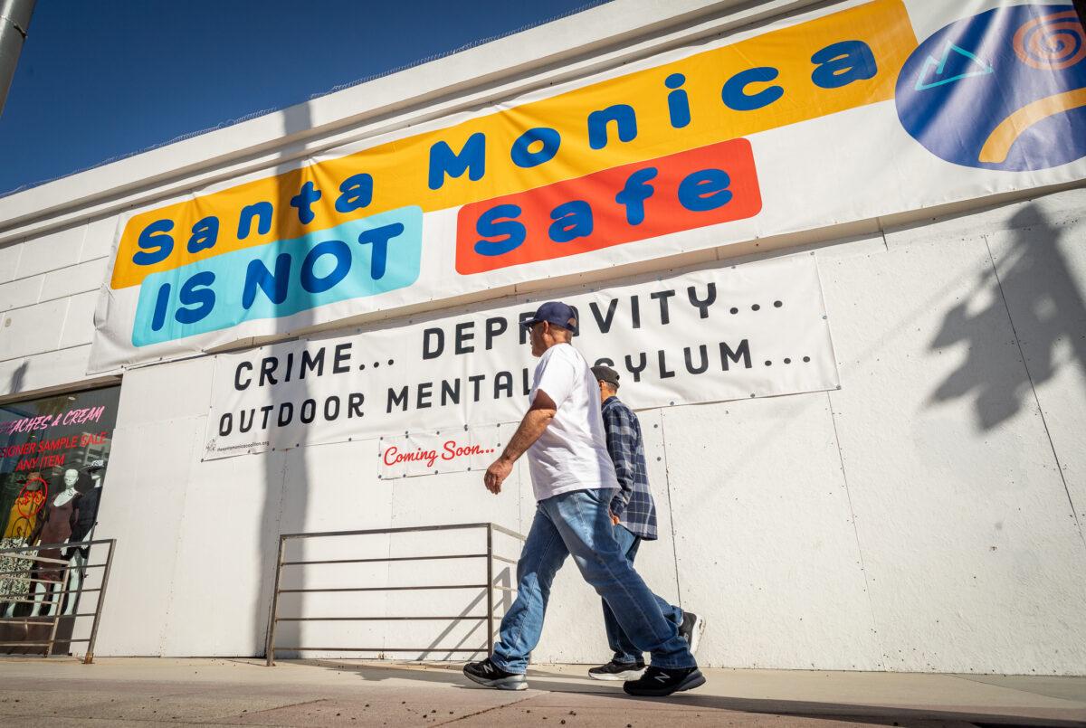 A sign sits on the display in front of a popular shopping area of Santa Monica, Calif., on Jan. 19, 2023. (John Fredricks/The Epoch Times)