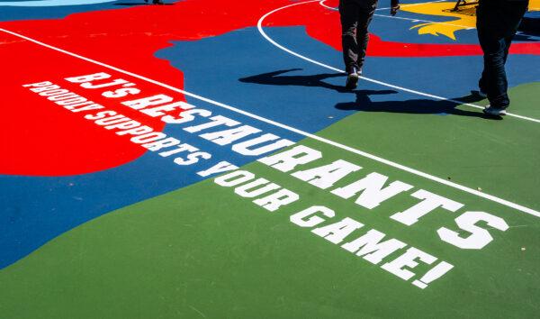 People enjoy the new basketball court donated by BJ's Restaurant in Santa Ana, Calif., on April 4, 2023. (John Fredricks/The Epoch Times)