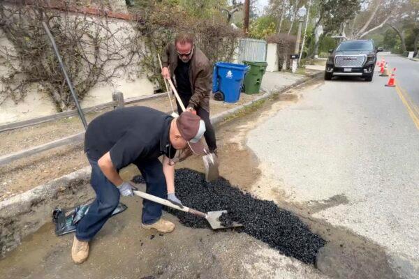 Former California Governor Arnold Schwarzenegger repairs a pothole on a street in his Los Angeles neighborhood on April 11, 2023. (The Office of Arnold Schwarzenegger via AP)