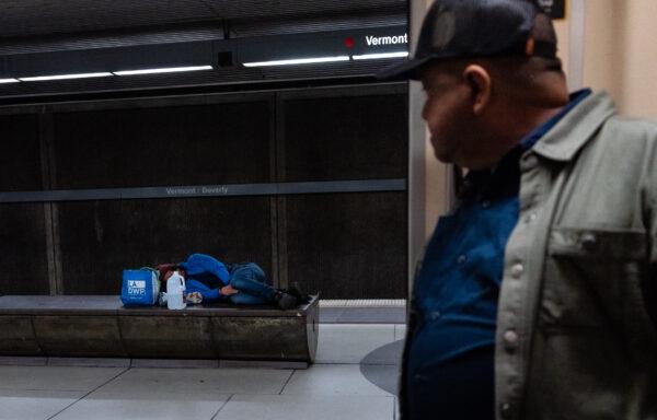 Homeless individuals scatter across on the Los Angeles Metro system in Los Angeles on April 19, 2023. (John Fredricks/The Epoch Times)