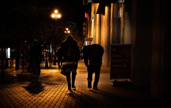 Jacqui Berlinn walks with her son Corey who's been homeless and addicted to fentanyl in San Francisco, Calif., on Feb. 22, 2023. (John Fredricks/The Epoch Times)
