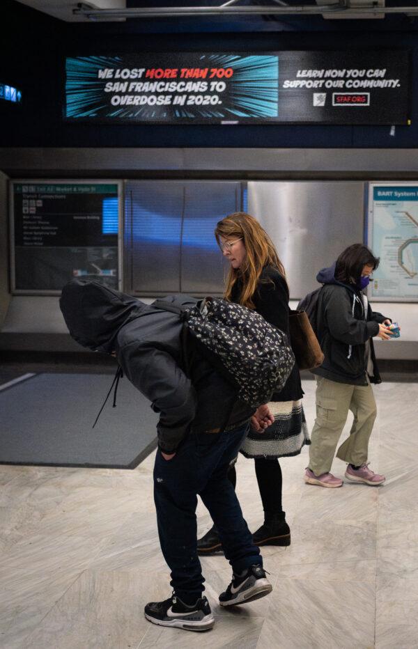 Jacqui Berlinn walks with her son Corey who is homeless and addicted to fentanyl in San Francisco, Calif., on Feb. 22, 2023. (John Fredricks/The Epoch Times)