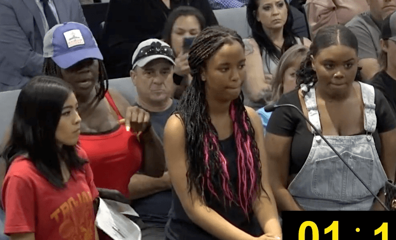 A mother interrupts her daughter as she speaks with other students at a Riverside Unified School District board meeting in Riverside, Calif., on April 27, 2023. (Screenshot via Riverside Unified School District)