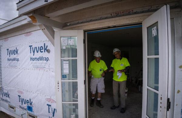 Habitat for Humanity members work on finishing two housing units for working-class families in Santa Ana, Calif., on May 5, 2023. (John Fredricks/The Epoch Times)