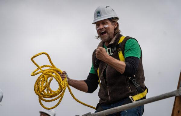 Habitat for Humanity patron Charles Antis encourages builders as they work on finishing two housing units for working-class families in Santa Ana, Calif., on May 5, 2023. (John Fredricks/The Epoch Times)