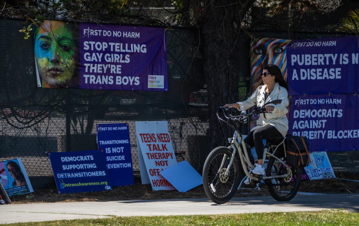 Posters made by detransition advocates who met outside of the annual Pediatric Endocrine Society conference held in San Diego, Calif., on May 6, 2023. (John Fredricks/The Epoch Times)