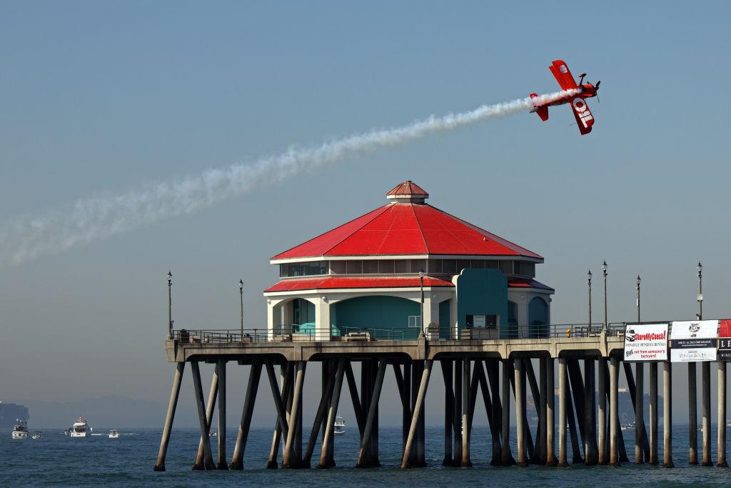 Mike Wiskus flies his Lucas Oil Pitts S-111B over the Huntington Beach Pier during the Pacific Airshow in Huntington Beach, Calif., on Oct. 1, 2021. (Michael Heiman/Getty Images)