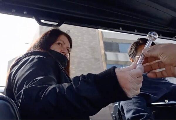 A worker from Homeless Health Care Los Angeles was seen handing out meth pipes to a homeless person. (Screenshot via TikTok/tony1963iceman)