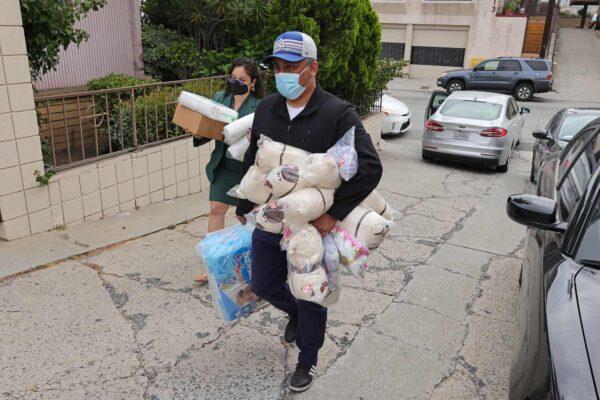 Officials and volunteers deliver diapers, supplies and toys to the St. Anthony Croatian Catholic Church where migrants have been transported in Los Angeles on June 14, 2023. (David Swanson/AFP via Getty Images)