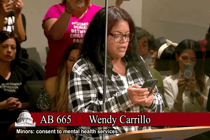 Wendy Minas, a Los Angeles mother of five children, speaks at a state Senate committee meeting in Sacramento on June 20, 2023. (Screenshot via Senate Judiciary Committee)