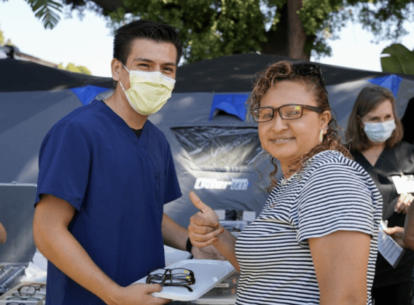 A Lestonnac Free Clinic volunteer helps a local resident in 2021. (Courtesy of Lestonnac Free Clinic)