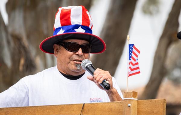 Huntington Beach 4th of July Bicycle Cruise organizer Ed Romo greets riders in Huntington Beach, Calif., on July 1, 2023. (John Fredricks/The Epoch Times)