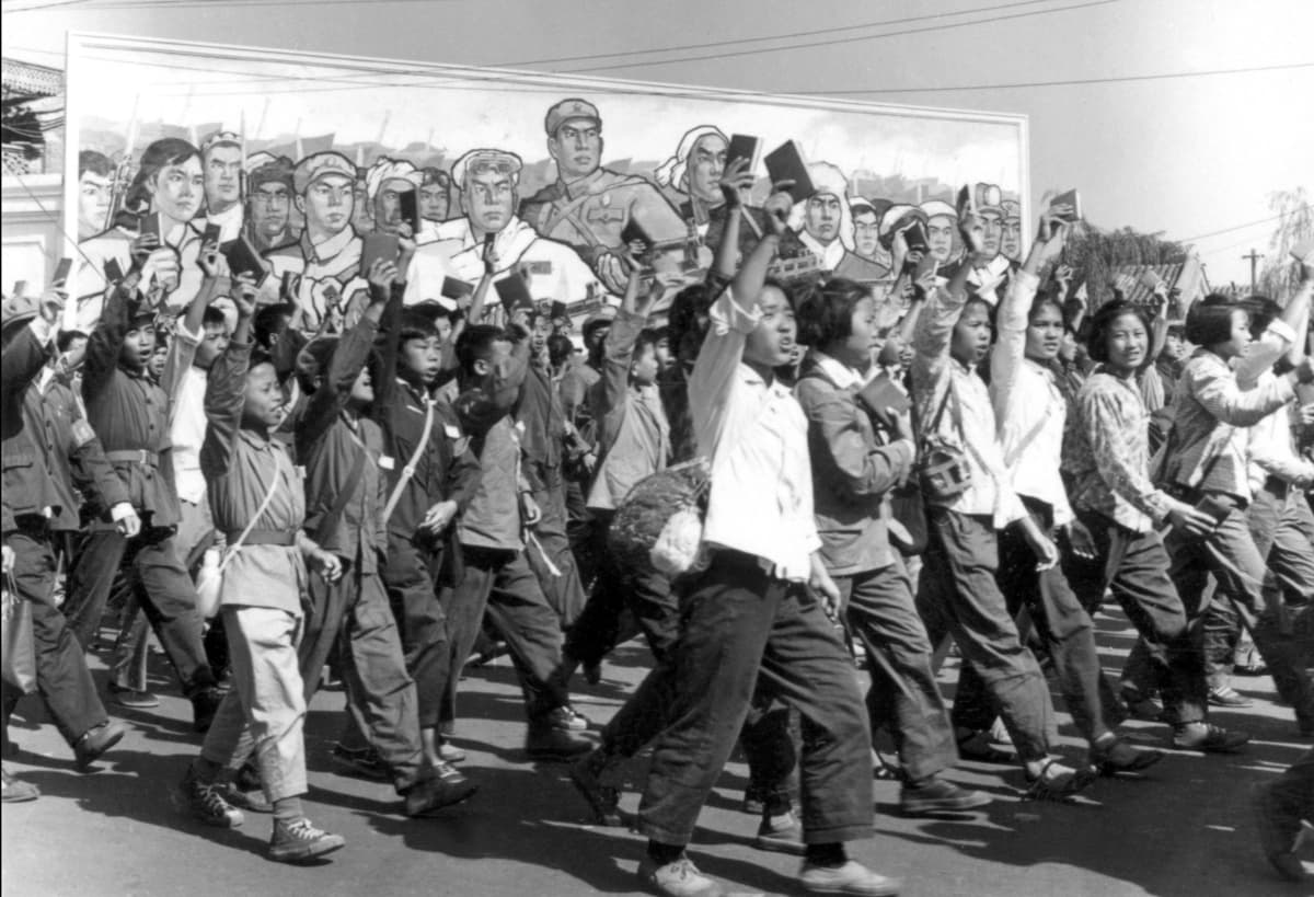 Red Guard members wave copies of Chairman Mao’s “Little Red Book” at a parade in Beijing during the Cultural Revolution in June 1966. (Jean Vincent/AFP via Getty Images)