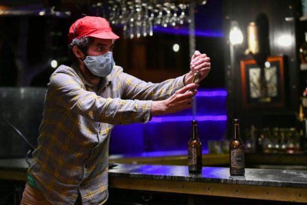 Cameraman Aaron Wise meters light during production of the indie feature film “The Star City Murders” in Los Angeles on July 1, 2021. (Rodin Eckenroth/Getty Images)