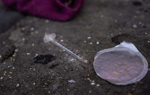 An empty syringe sits on a sidewalk in San Francisco, Calif., on Feb. 23, 2023. (John Fredricks/The Epoch Times)