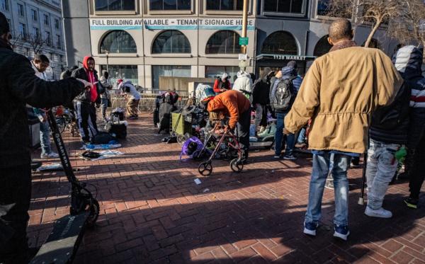 Homeless people gather near alleged drug dealers in the Tenderloin District of San Francisco on Feb. 22, 2023. (John Fredricks/The Epoch Times)