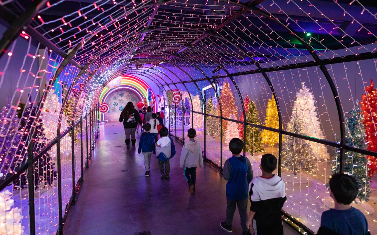 Children enjoy the seasonal "Winter Lights Festival" exhibit at the Discovery Cube center in Santa Ana, Calif., on Dec. 16, 2022. (John Fredricks/The Epoch Times)