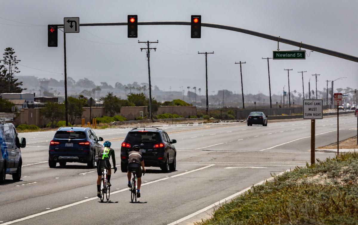 Cyclists ride along PCH in Huntington Beach, Calif., on May 20, 2021. (John Fredricks/The Epoch Times)