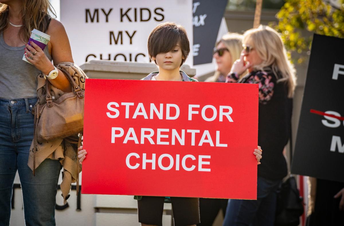 Parents and students gather in protest of school district policies at the Placentia Yorba Linda Unified School District offices in Placentia, Calif., on Jan. 18, 2022. (John Fredricks/The Epoch Times)