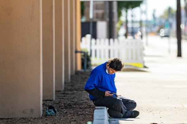 A grocery store worker taking a break in Costa Mesa, Calif. on March 1, 2021. (John Fredricks/The Epoch Times)