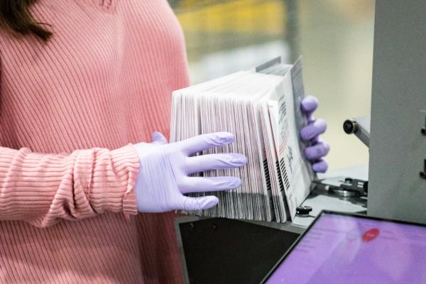 Workers process California ballots at a Los Angeles Registrar site at the Los Angeles Fair Grounds in Pomona, Calif., on Aug. 31, 2021. (John Fredricks/The Epoch Times)