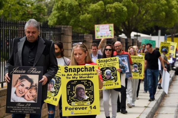 Steve Filson (L), whose daughter Jessica Filson died in January 2020 of fentanyl poisoning, and Amy Neville (R), whose son Alexander Neville died in June 2020 at the age of 14 of fentanyl poisoning, march with family and friends to protest outside of Snap, Inc. headquarters, makers of the Snapchat social media application, in Santa Monica, Calif., on June 4, 2021. (Patrick T. Fallon/AFP via Getty Images)
