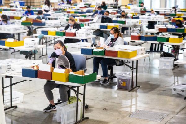 Voting center workers process ballot votes in Pomona, Calif., on Aug. 31, 2021. (John Fredricks/The Epoch Times)