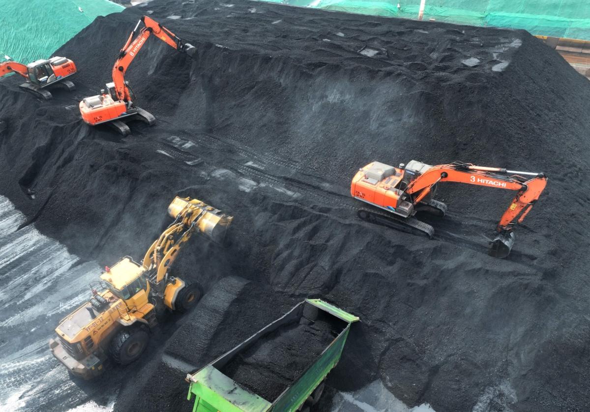 Coal is loaded onto trucks for delivery to power generation plants, after being unloaded from ships at the port in Lianyungang, in China's eastern Jiangsu Province on July 12, 2023. (STR/AFP via Getty Images)