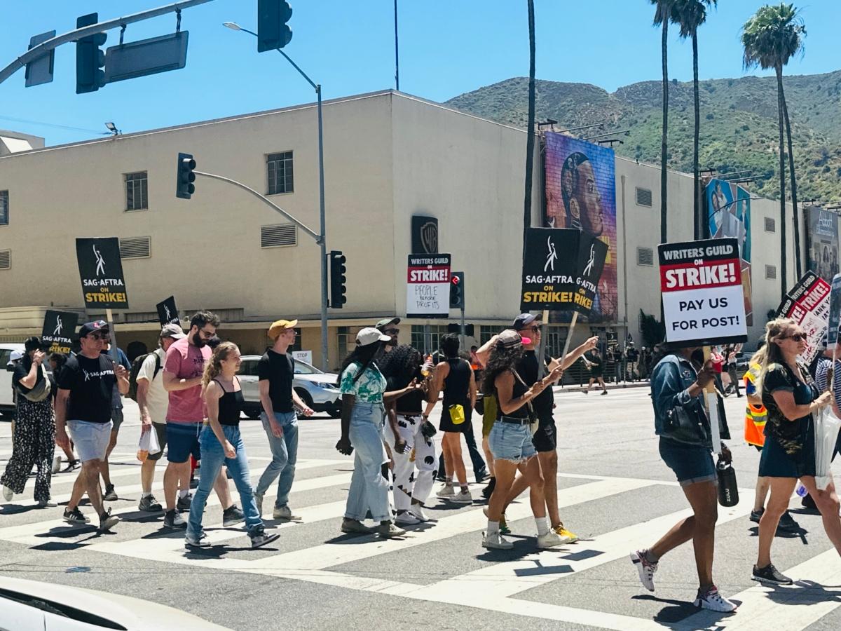 Hollywood actors join the industry’s writers on the picket line after their union, the Screen Actors Guild-American Federation of Television and Radio Artists (SAG-AFTRA), authorized a strike against major studios, outside of Warner Bros. Studios in Burbank, Calif., on July 14, 2023. (Jill McLaughlin/The Epoch Times)