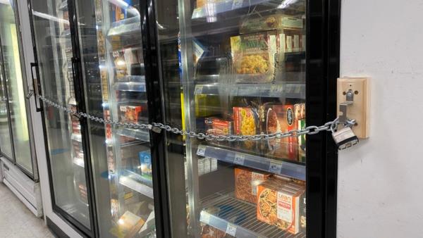 A close-up view of chains securing a freezer full of food in a Walgreens store in San Francisco on July 18, 2023. (Lear Zhou/The Epoch Times)