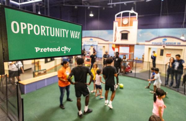 Players of the Orange County Soccer Club teach children soccer maneuvers at the Pretend City Children’s Museum in Irvine, Calif., on July 28, 2023. (John Fredricks/The Epoch Times)