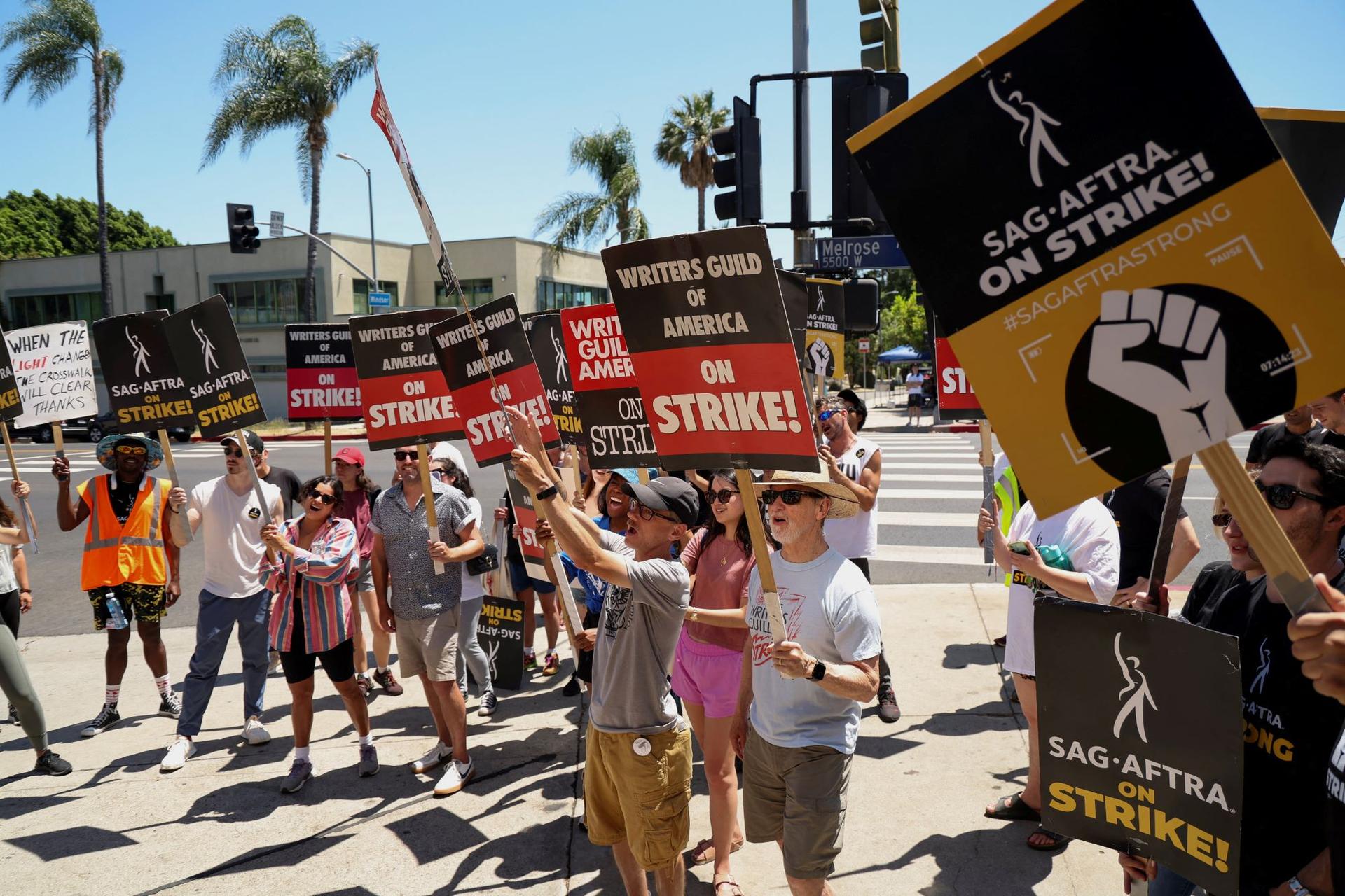 SAG-AFTRA actors and Writers Guild of America (WGA) writers walk the picket line during their ongoing strike outside Paramount Studios in Los Angeles on Aug. 2, 2023. (Mario Anzuoni/Reuters)
