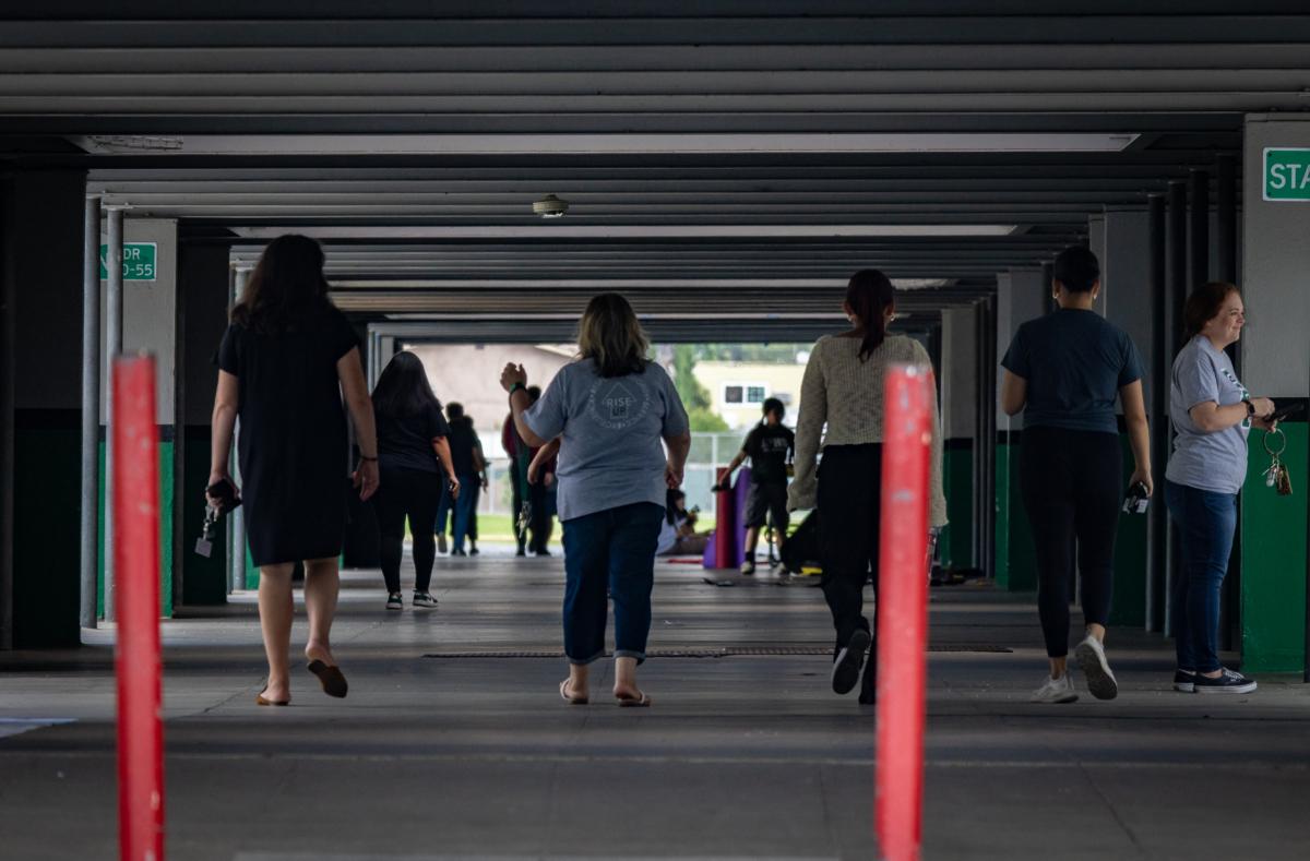Staff and students walk through a hallway at Buena Park High School in Buena Park, Calif., on Aug. 11, 2023. (John Fredricks/The Epoch Times)