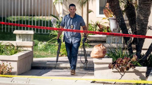 Investigators remove firearms from the house of Orange County Superior Court Judge Jeffrey Ferguson in the 8500 block of E. Canyon Vista Dr. in Anaheim, Calif., on Aug. 4, 2023. (Paul Bersebach/The Orange County Register via AP)