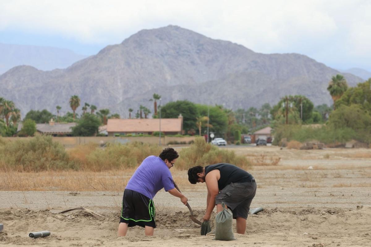 Residents shovel and fill sandbags from the desert along the side of the road as the path of Hurricane Hilary heads north toward southern California, in Indio, California, Aug. 19, 2023. (David Swanson/AFP via Getty Images)