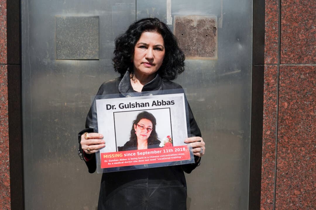 Rushan Abbas, executive director of the Campaign for Uyghurs, holds a photo of her sister, Dr. Gulshan Abbas, during a rally in New York City on March 22, 2021. Dr. Gulshan Abbas, a retired Uyghur medical doctor, was sentenced in a secret trial to 20 years imprisonment for alleged terrorist activities. (Timothy A. Clary/AFP via Getty Images)