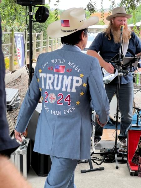 Tien Tran, one of the “front row joes” at Trump rallies, sports a hat, blazer, and tie embroidered with “The World needs Trump more than ever" at a private event held at a ranch in northern Orange County, Calif., on Aug. 19, 2023. (Brad Jones/The Epoch Times)