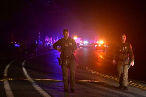 Police officers are seen on a blocked-off road after a shooting at nearby bar "Cook's Corner" in Trabuco Canyon, Calif., on August 23, 2023. (Frederic J. Brown/AFP via Getty Images)