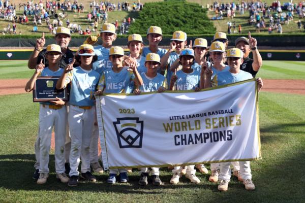 Members of the West Region team from El Segundo, California pose with the championship banner after defeating of the Caribbean Region team from Willemstad, Curacao to win the Little League World Series Championship Gameat Little League International Complex in South Williamsport, Pa., on Aug. 27, 2023. (Tim Nwachukwu/Getty Images)