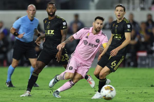 Lionel Messi (10) of Inter Miami CF watches looks on following a pass against Kellyn Acosta (23) and Ilie Sánchez (6) of Los Angeles FC during a match between Inter Miami CF and Los Angeles Football Club at BMO Stadium in Los Angeles on Sept. 3, 2023. (Harry How/Getty Images)