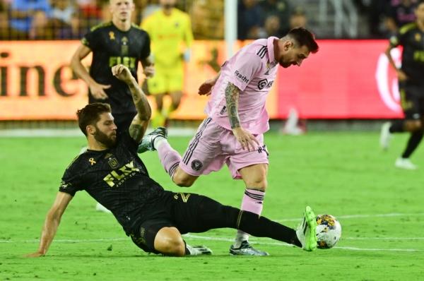 LAFC's US defender (24) Ryan Hollingshead makes a slide tackle on Inter Miami's forward (10) Lionel Messi during the Major League Soccer (MLS) football match between Inter Miami CF and Los Angeles FC at BMO Stadium in Los Angeles on Sept. 3, 2023. (Frederic J. Brown/AFP via Getty Images)
