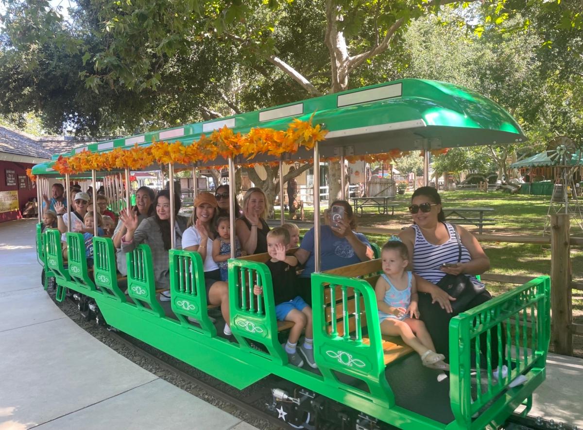 Visitors ride the Irvine Park Railroad's new electric train in Orange, Calif., on Sept. 7, 2023. (Carol Cassis/The Epoch Times)