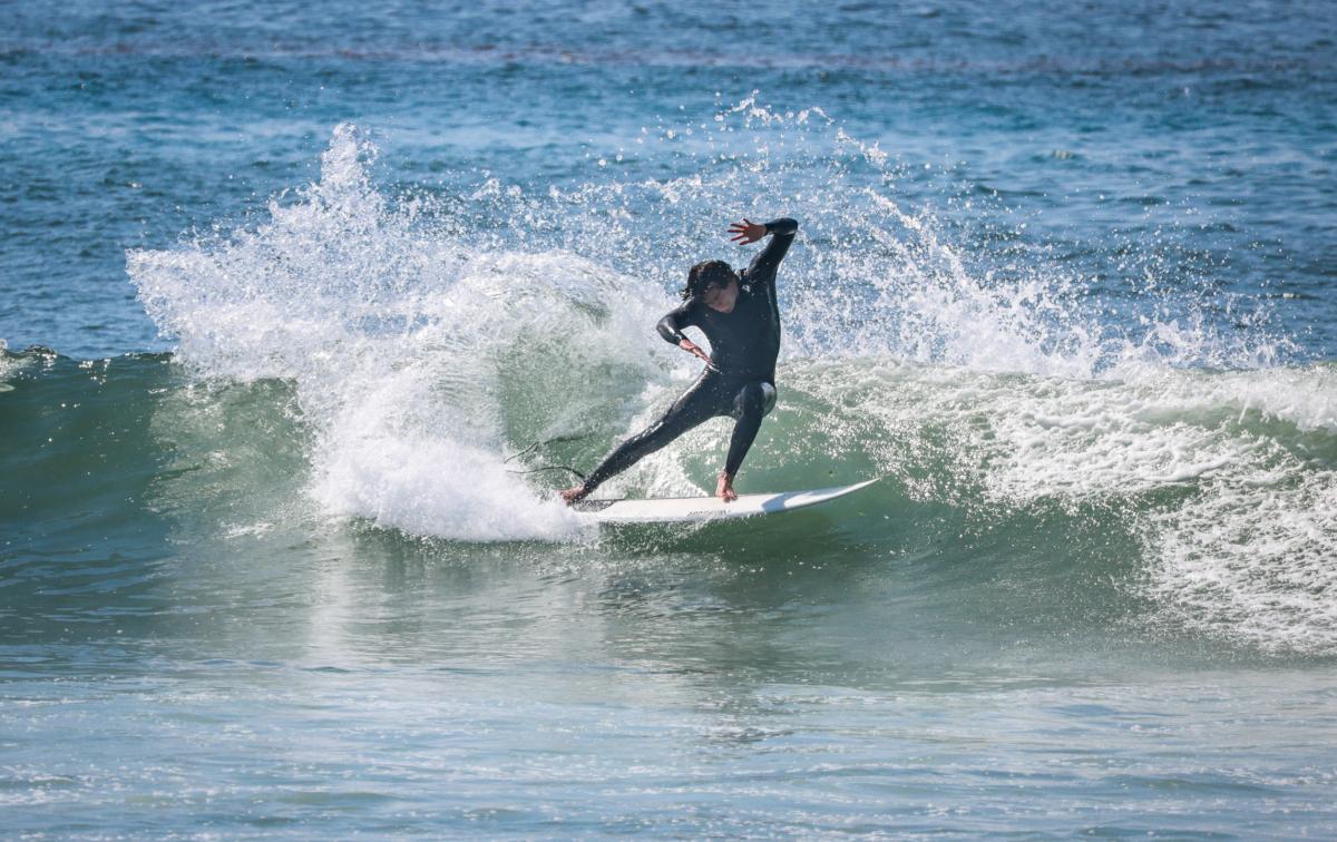 Surfers ride waves in front of the staging area of the Rip Curl WSL Finals of Lower Trestles in San Clemente, Calif., on Sept. 8, 2023. (John Fredricks/The Epoch Times)